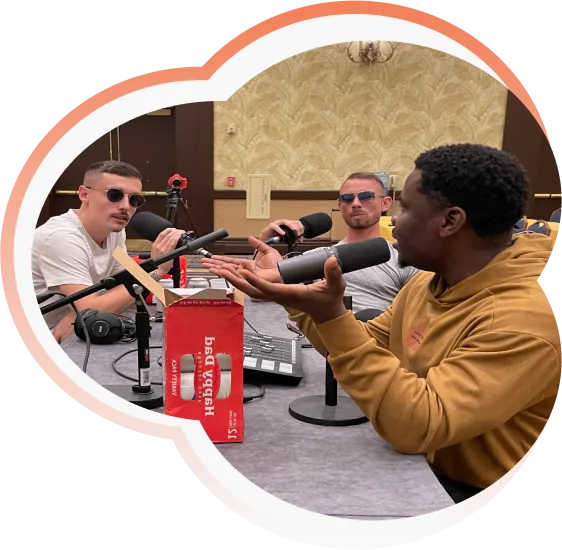Luqman speaking with two guests during a podcast recording